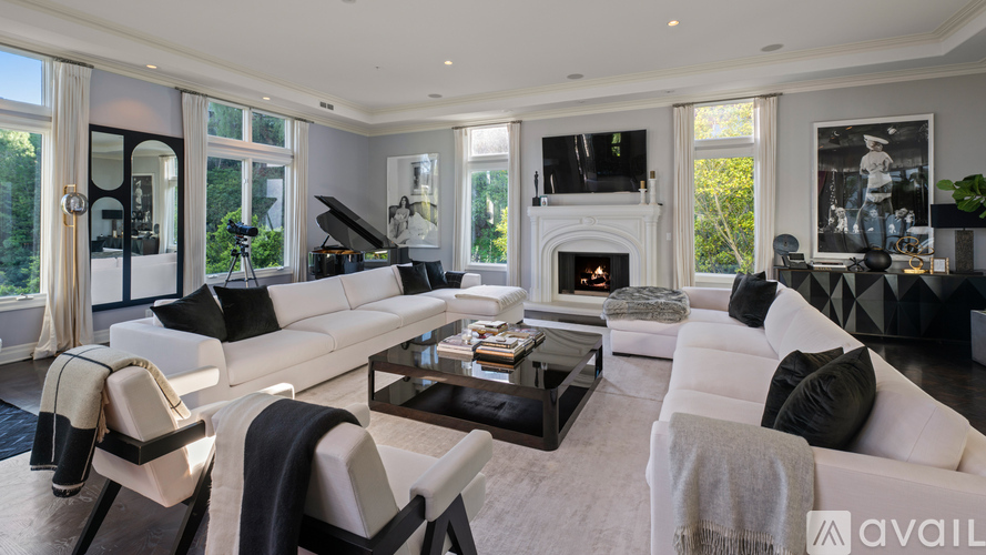 A modern living room with a white sofa and a black coffee table.