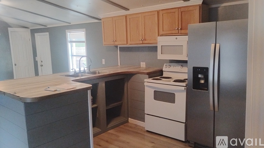 A kitchen with a stainless steel refrigerator and white oven.