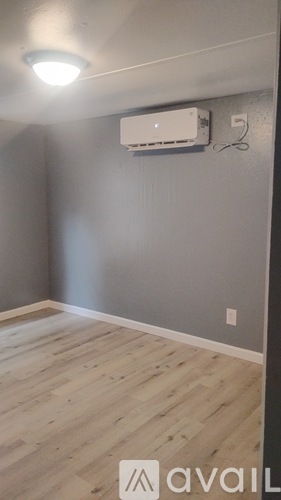 A room with a wall-mounted air conditioner unit.