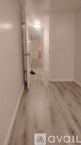 A hallway with a broom in the middle.