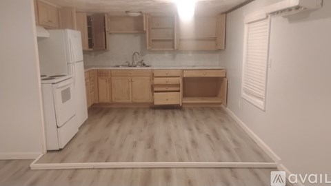 A kitchen with wooden cabinets and a white refrigerator.