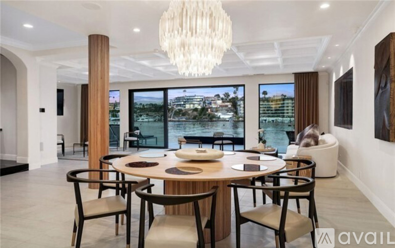 A modern dining room with a large table and chairs.