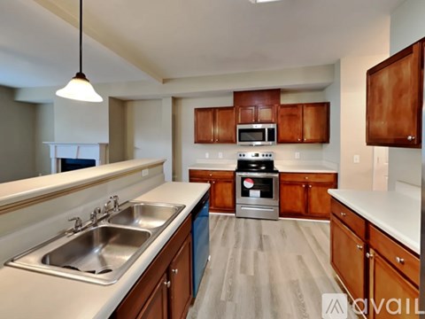 A kitchen with a stove top oven and a sink.