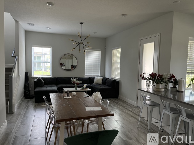 A dining room with a wooden table and chairs.
