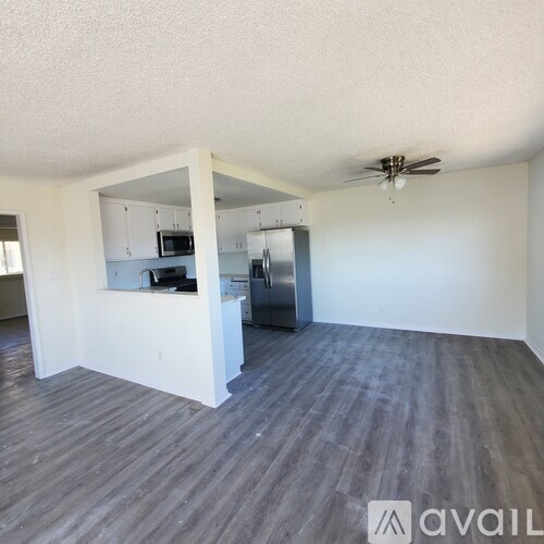 A kitchen area with a refrigerator, microwave, and oven.