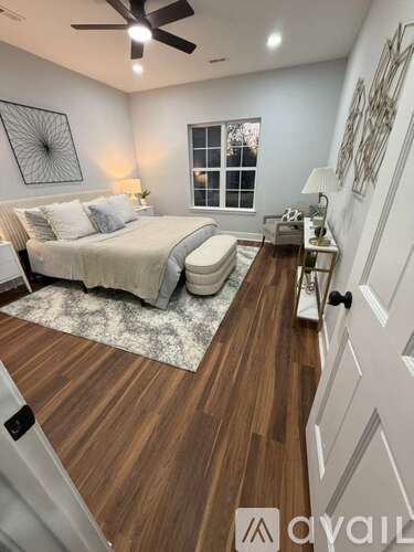 A bedroom with a bed, a toilet, and a ceiling fan.