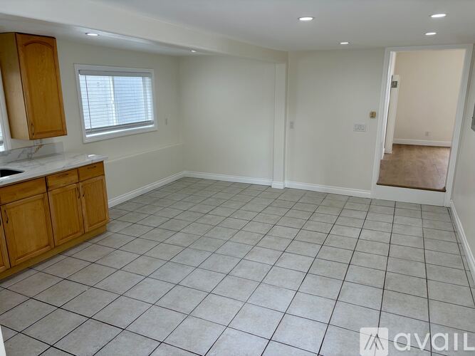A spacious room with a tiled floor and a window.