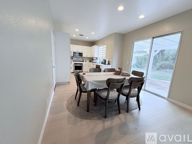 A dining room with a table set for four.