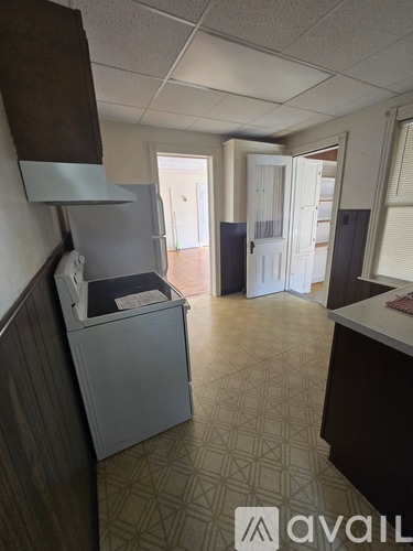 A kitchen area with a dishwasher and a refrigerator.