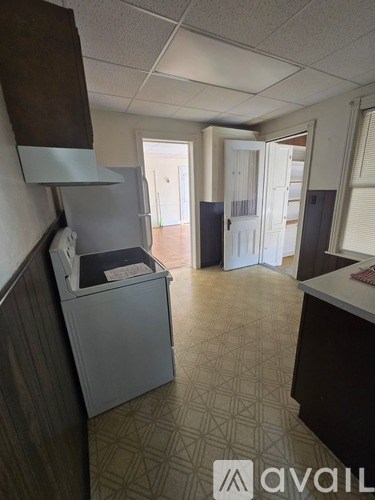 A kitchen area with a dishwasher and a refrigerator.