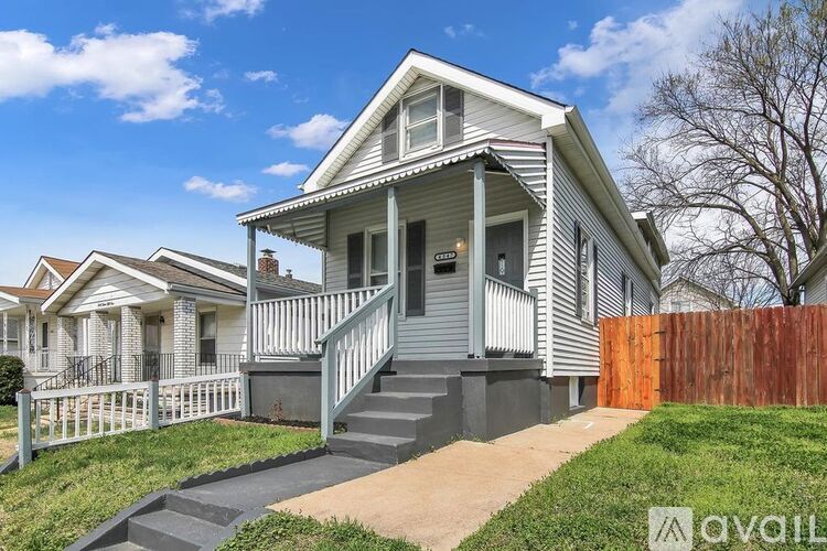 A house with a front yard and a fence.