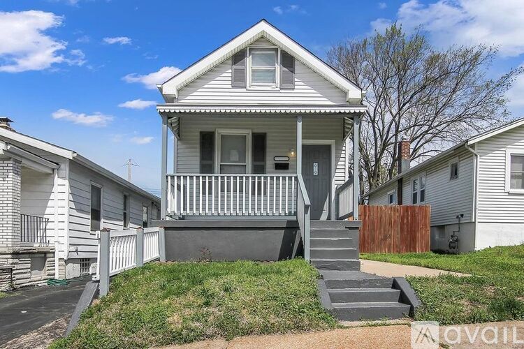 A house with a front porch and a staircase leading to the front door.