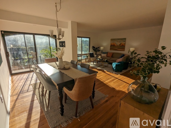 A modern dining room with a wooden table and chairs.