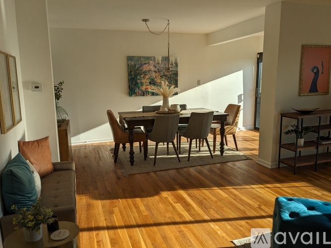 A living room with a dining table and chairs.