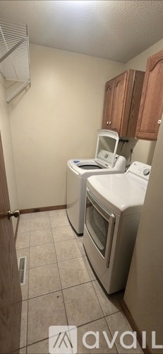 A kitchen with a white oven and a white microwave.