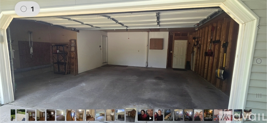 A garage with a white door and a brown wall.