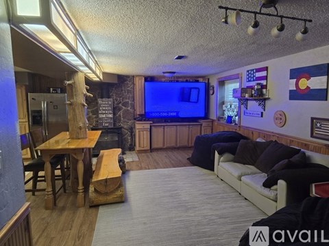 A living room with a television and a couch.