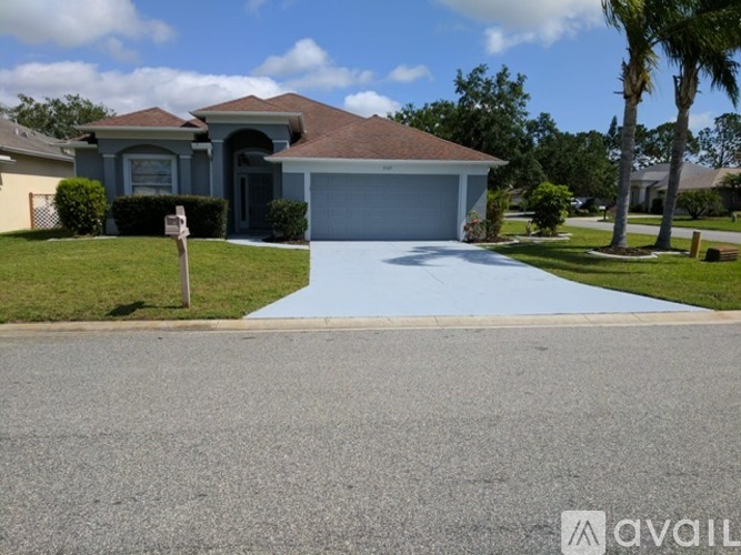 A house with a blue garage door is for sale.