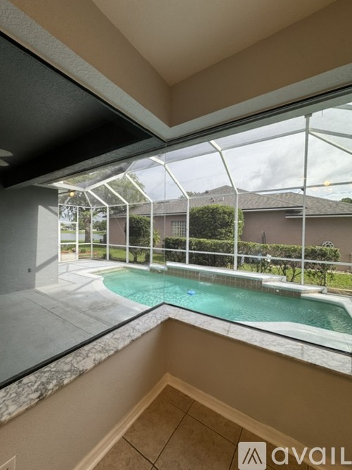 A balcony with a pool and a glass railing.