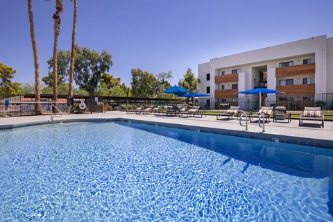 A swimming pool with a building in the background.