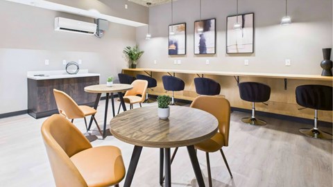 A modern dining area with a round table and chairs.
