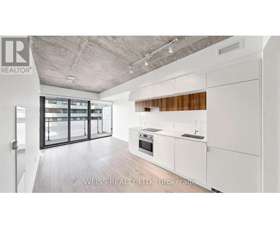 A modern kitchen with white cabinets and a wooden backsplash.