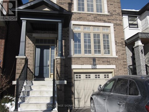 A grey car is parked in front of a house with a Royal LePage sign.