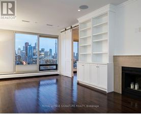 A spacious living room with a view of the city skyline.