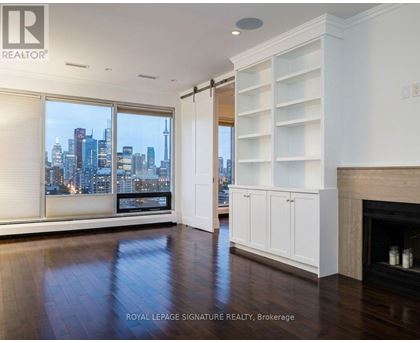 A spacious living room with a view of the city skyline.