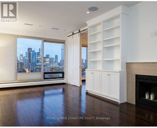 A spacious living room with a view of the city skyline.
