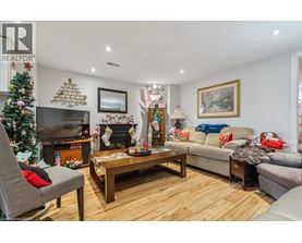 A living room with a Christmas tree and a fireplace.