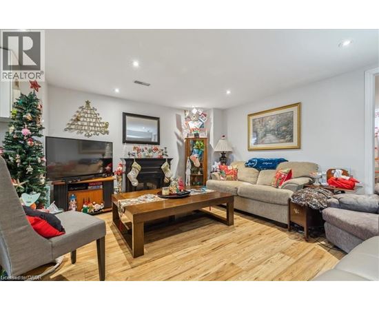 A living room with a Christmas tree and a fireplace.
