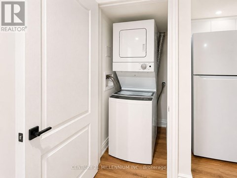A white dishwasher is in a small kitchen.
