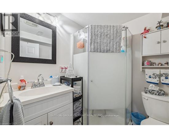 A bathroom with a white sink and a white toilet.