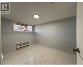 A room with a window and a tiled floor.