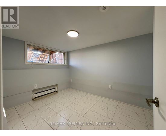 A room with a window and a tiled floor.