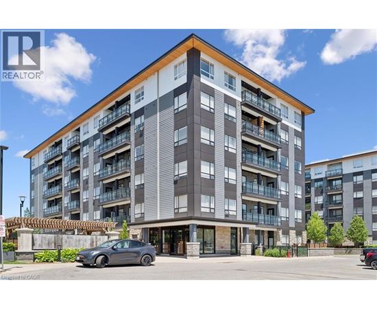 A modern apartment building with a car parked in front.