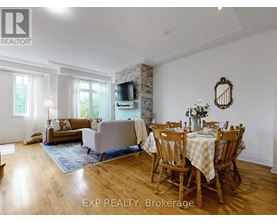 A dining room with a wooden table and chairs.