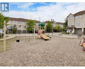 A playground with a slide, swings, and sandbox in a residential area.