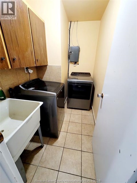 A small kitchen with a sink, stove and a dishwasher.