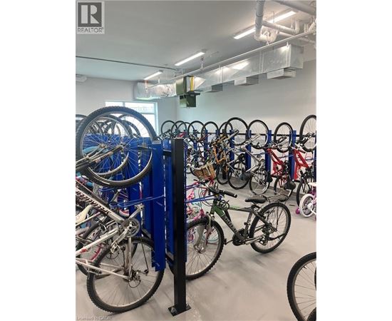A bike rack full of bicycles in a room.
