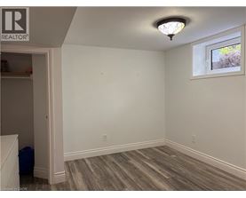 A room with a window and a wooden floor.