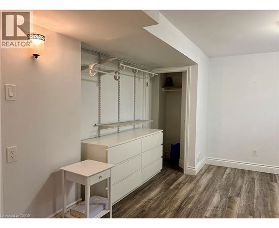 A room with a white cabinet and a small table.