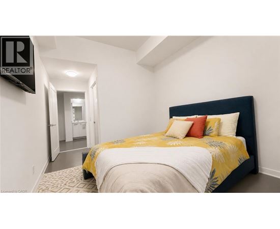 A bedroom with a bed, pillows, and a sign that says REALTOR.