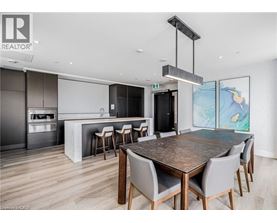 A modern dining room with a large table and chairs.