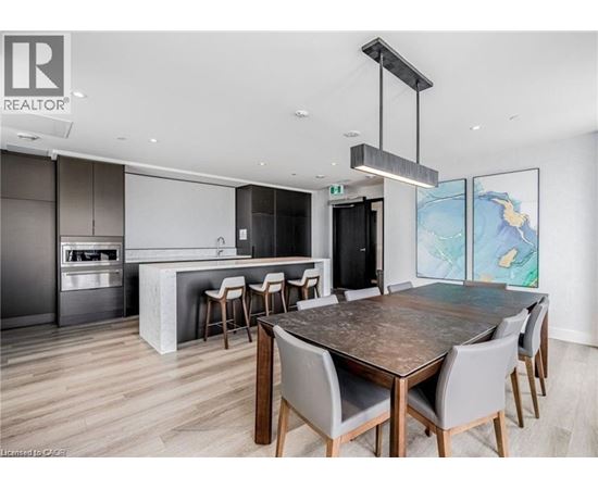 A modern dining room with a large table and chairs.