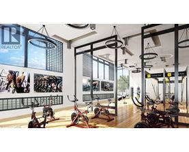 A gym with a REALTOR sign on the wall.