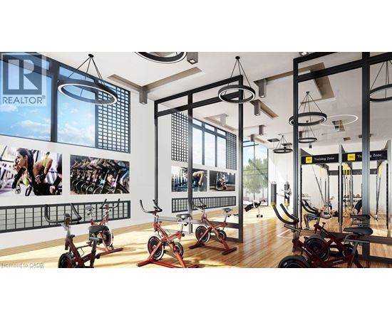 A gym with a REALTOR sign on the wall.