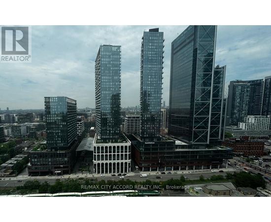 A cityscape with tall buildings and a cloudy sky.