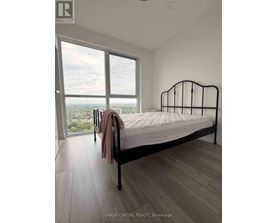A bedroom with a large bed and a view of the city.